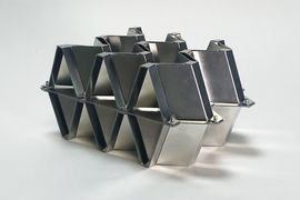 A latticed aluminum object, shaped like 3 diamonds on one end.